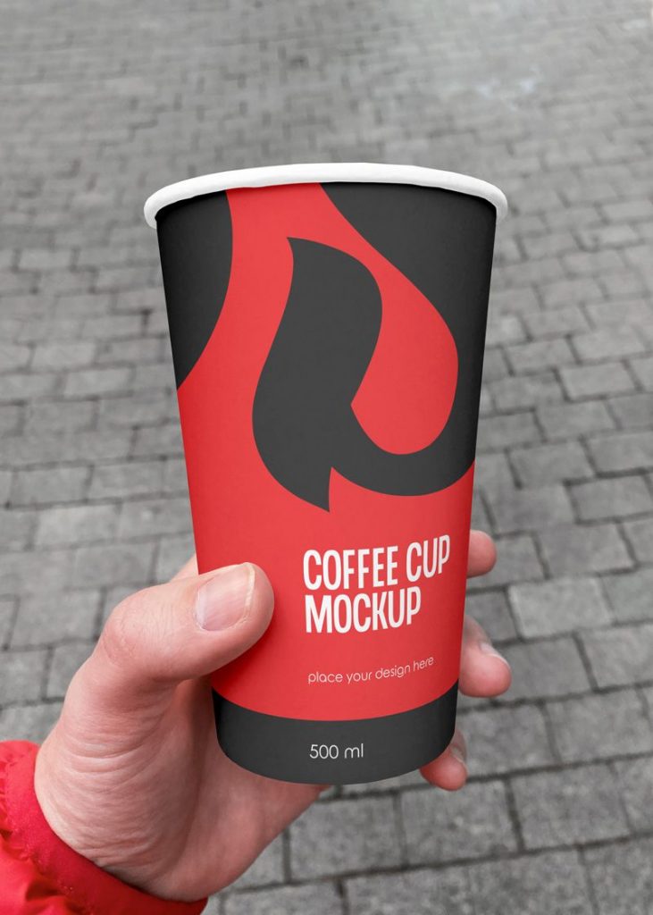 Free Tumbler Coffee Cup in Hand Mockup