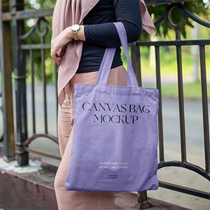 small_free-woman-in-park-holding-canvas-bag-mockup